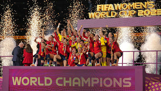 Spain's women's national team celebrates on stage after winning the Women's World Cup.